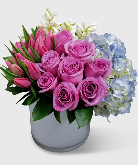 Pink tulips, purple roses, white hyacinth, blue hydrangea and more. 