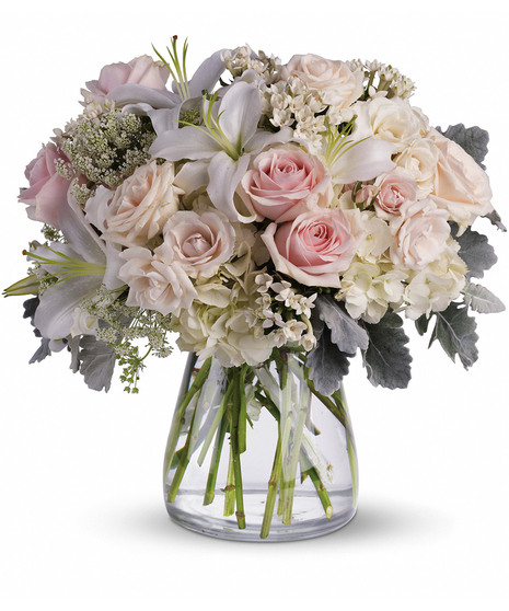 Pink and cream flowers in an elegant arrangement.