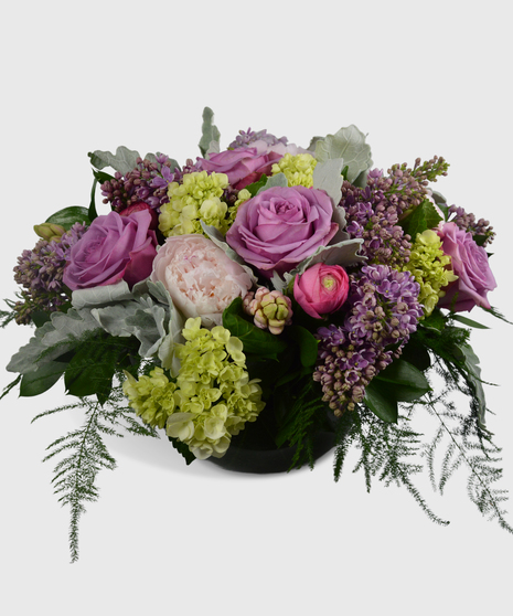 Pink peonies, purple lilac, hydrangea and roses in a high-end design.