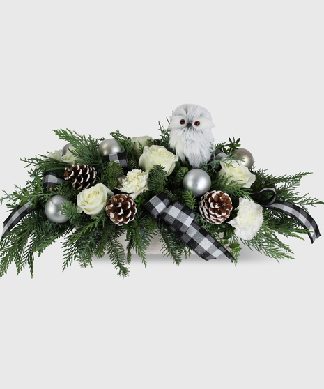 White flowers, silver balls, buffalo plaid ribbon and winter greens featuring a white owl