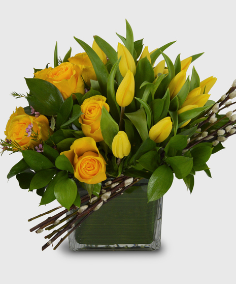 Unique vase with yellow tulips, yellow roses and pussy willow